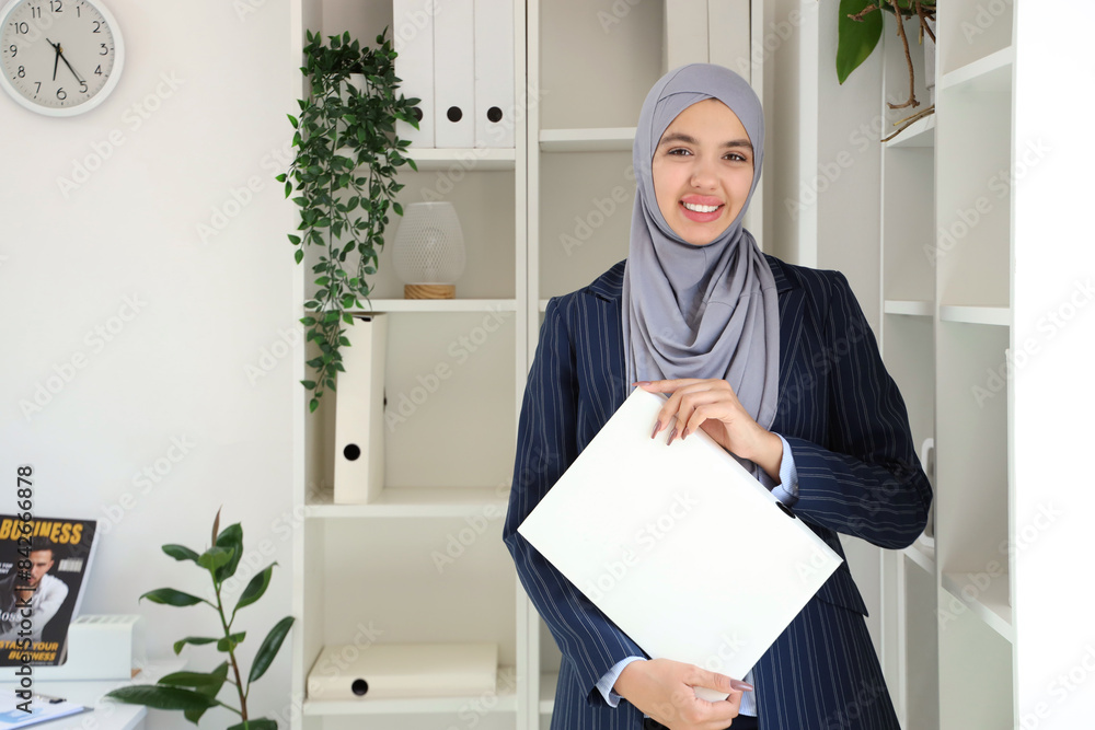 Sticker Beautiful Muslim businesswoman with laptop in office