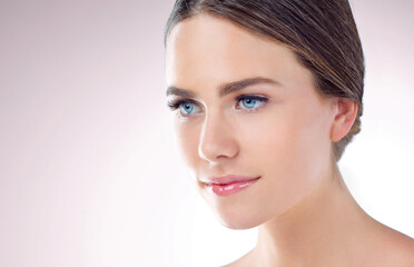 Obraz premium Beauty, skincare and woman in studio for glow, makeup or thinking of wellness isolated on background mockup space. Cosmetics, face and model in spa for dermatology, health and shine for aesthetic