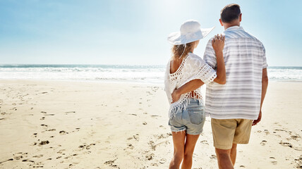 Love, hug and back of couple at a beach with support, care and trust while bonding on summer break...
