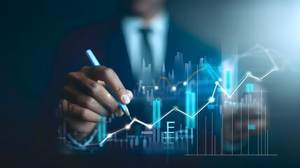 Businessman drawing upward arrows on a virtual screen with a financial graph and stock market growth 