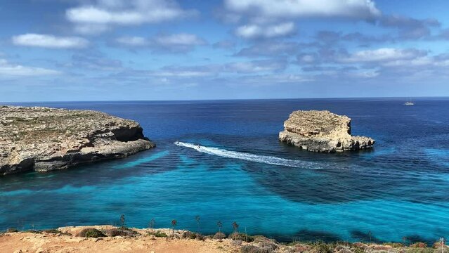 Comino Island Malta, Water scooters in between to rocks. Visiting caves in Comino . High quality 4k footage