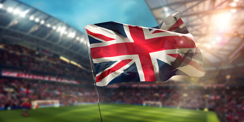 Flag of England waving in the wind, with a blurred soccer stadium in the background