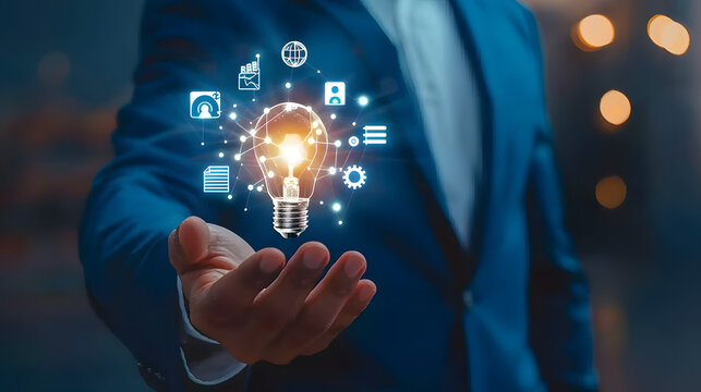 Businessman holding light bulb with digital marketing icons on hand. business innovation and creative idea concept. photo of man in blue suit 