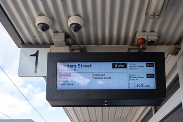 A monitor hanging at Balaclava train station displays a live updated train schedule on the...