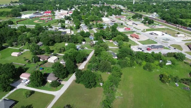Flyover Fairland agriculture town along Conner Avenue with baseball fields, railroad tracks, low density business and residences building, southern Ottawa County, Oklahoma, agro-town country area