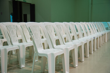Plastic chairs arranged in a row in an auditorium