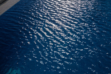 Swimming Pool Surface With Light Reflection and Water Ripple Patterns
