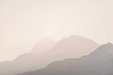 Obraz premium Panorama of a mountain range in the morning at dawn, tonal perspective of mountains in the morning haze in the Pamirs in Tajikistan