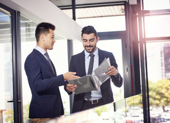 Business people, teamwork and discussion of document or legal case for advice in office at law...