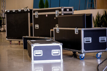 Flightcase of concert music and video equipment stacked behind the stage
