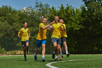 Joyful Victory Celebration. Group of young boys in bright yellow jerseys celebrating successful...