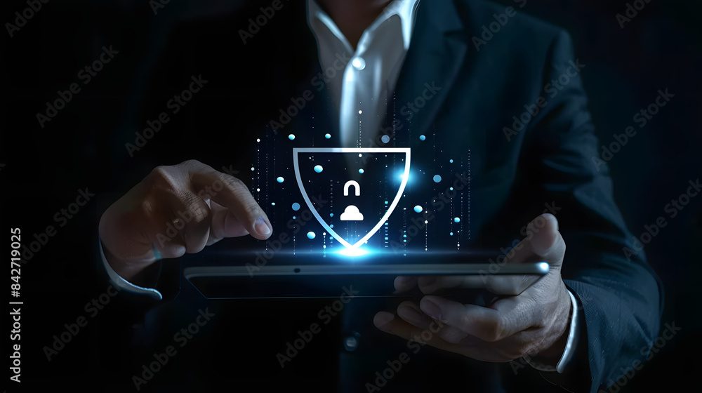Poster businessman using a tablet with a security shield icon for business protection from cyber attacks on
