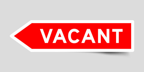 Red color arrow shape sticker label with word vacant on gray background