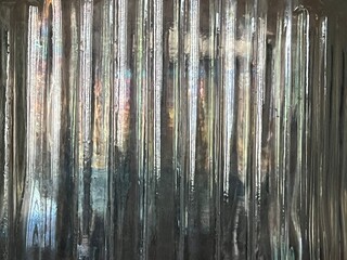 Abstract close up of ridged clear depression glass with a prism effect