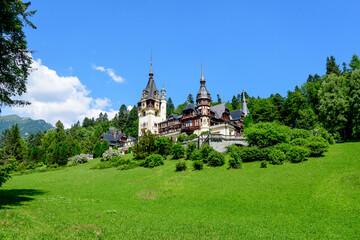 Fototapeta premium Beautiful neo-Renaissance building of Peles Castle (Castelul Peles) near Bucegi Mountains (Muntii Bucegi) in a sunny summer day in Sinaia town, Romania .
