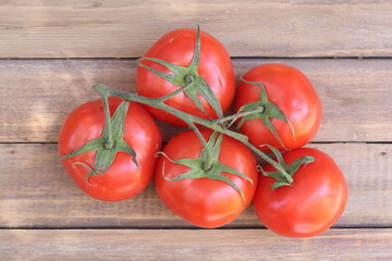Truss tomatoes on wooden table