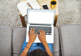 Fototapeta premium Screen, hands and laptop above on sofa in living room with person or journalist working from home. Student, education and typing on keyboard with studying, notes and fingers on couch in house.