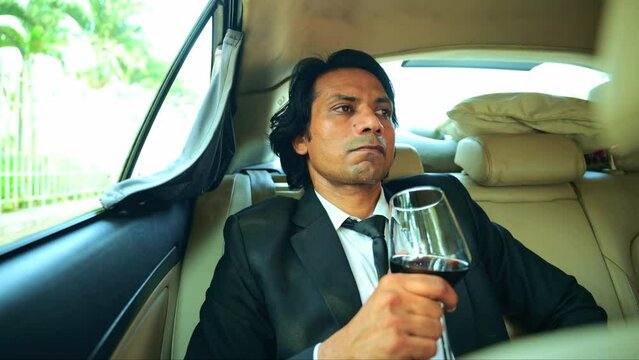 Serious businessman holding a glass of liquor