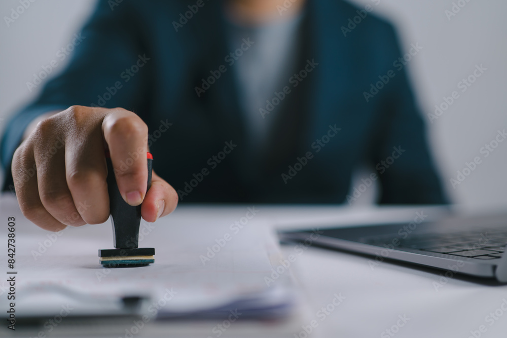Poster sign approved stamp on document to permit and certify for work document and visa at desk
