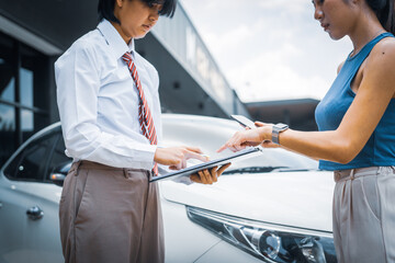A young businesswoman is navigating car insurance options at her desk, considering premiums, deductibles, and coverage while understanding policies and managing claims efficiently.