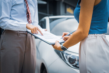 A young businesswoman is navigating car insurance options at her desk, considering premiums, deductibles, and coverage while understanding policies and managing claims efficiently.