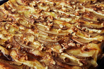 freshly baked homemade pie. Puff pastry pie with pear slices, camembert, honey, walnuts close up