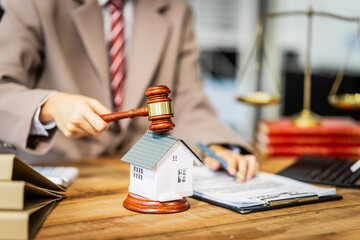 A young businesswoman is working at her desk, reviewing contracts and preparing for litigation, while also managing her responsibilities as a homeowner involved in renovation and real estate.