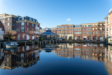 Reflections in the water of the harbor at the Voorhaven quarter in the center of Sassenheim, South Holland in the Netherlands