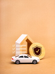 Home and car insurance concept. Shield icon on round wood badge and checklist with white toy car,...