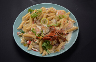 Penne Pasta with Prawns or Shrimps, lemon and garlic on white, top view, copy space. Lemon pasta with sauteed shrimps, fresh seafood.