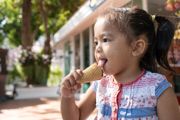 Cute asian kid girl eating ice cream travel outdoor summer city park ice-cream shop