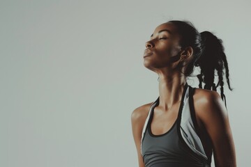 Fototapeta premium Athletic Fashion Model in Stylish Activewear Poses Against White Background with Copy Space