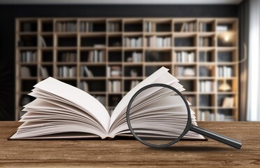 magnifying glass on the page of book, education concept