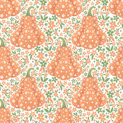 Seamless pattern of had-drawn orange pumpkins and tiny flowers on a white background. Cute ditsy fabric and packaging design.