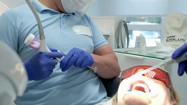 Dentist Man Extract Patient Tooth Dental Clinic Extraction Procedure Jaws Wrench. Ultra High Definition. UltraHD,