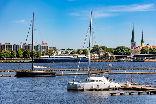 LATVIA, RIGA, 05, JUNE, 2024: Sailing yachts moored near a wooden pier in Daugava river harbor at Kipsala, Riga, Latvia.	