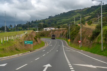 Old truck on a road with direction signs of the municipality of Tanuja in Colombia