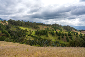 Colombian countryside with forest between mountains on a cloudy day