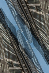 symmetry and mirrored geometry pattern, reflected skyscrapers and modern buildings abstract background, lines and tunnel futuristic technology concept