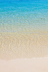 Ripples of the crystal-clear sea waters near the sand of Praia do Dentista, in Ilha Grande, RJ, Brazil.