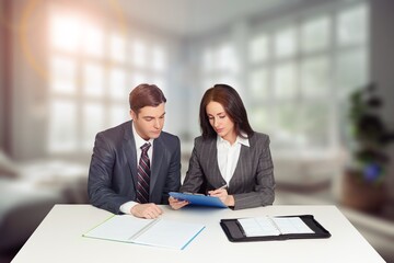 Smiling man and woman working on computer