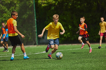 Dynamic Sports Training. Young soccer players practicing dribbling and passing skills during outdoor game. Coordination and sportsmanship. Concept of sport, school, childhood, hobby, active lifestyle