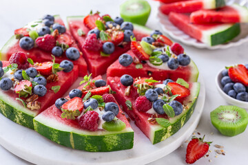 fresh sweet and tasty watermelon pizza with yogurt and fresh berries