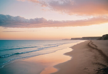 Obraz premium a beach with sand and water at sunset