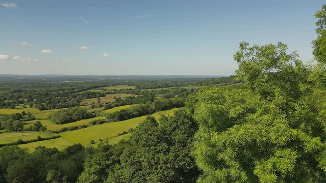 Rising drone shot over the Weald of Kent looking south west from from One Tree Hill near Sevenoaks, Kent, UK. Early June.