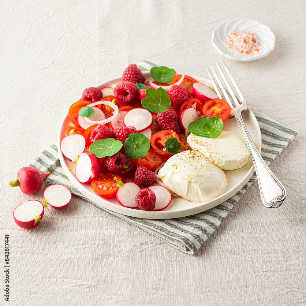 Wall mural summer salad with raspberries, cherry tomatoes, fresh radishes, mozzarella cheese and nasturtium lea