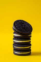 Oreo cookie stack isolated on yellow background