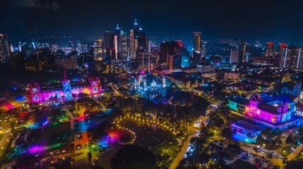 Aerial view of a cityscape illuminated with vibrant rainbow colors at night, celebrating Pride Month.