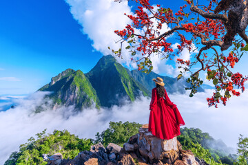 Asian girl on top Viewpoint of Nong Khiaw - a secret village in Laos. Stunning scenery of limestone cliff valley covered with fog.