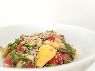 Tasty salad with egg, sunflower seeds and cherry tomato. 